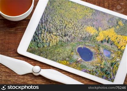 fall colors in a mountain valley in Colorado - reviewing aerial image from Kenosha Pass on a digital tablet