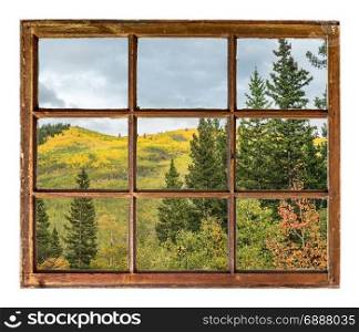 fall colors in Colorado Rocky Mountains as seen through vintage, grunge, sash window with dirty glass