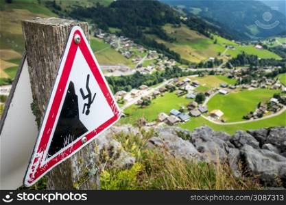 Fall danger warning sign near a high cliff. Fall danger warning sign near a cliff