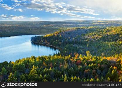 Fall forest and lake with colorful trees from above in Algonquin Park, Canada