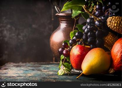 Fall fruits and vegetables on dark rustic kitchen table at wooden background, side view,copy space, close up