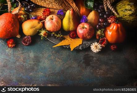 Fall fruits and vegetables on dark rustic wooden background, top view,border. Autumn harvest concept.