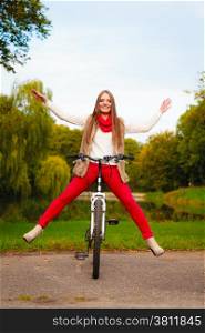 Fall lifestyle concept, harmony freedom. Beauty young woman fashion girl relaxing in autumnal park with bicycle, outdoor