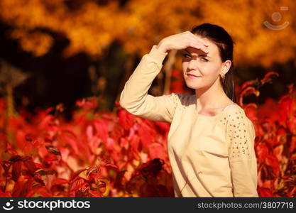 Fall lifestyle concept, harmony freedom. Portrait young woman girl relaxing walking in autumnal park. Golden colorful leaves background