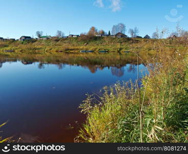 Fall River, reflected in the water autumn trees. Arkhangelsk region, Russia