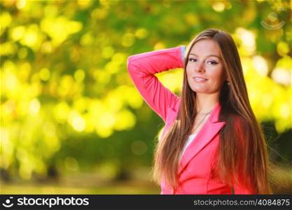 Fall season. Portrait of happy girl young woman in pink in autumnal park forest. Outdoor.