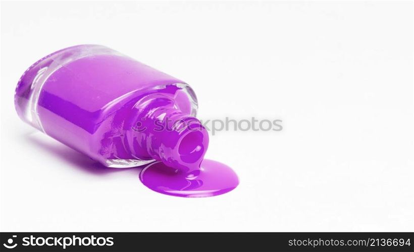 fallen pink nail polish bottle isolated white surface