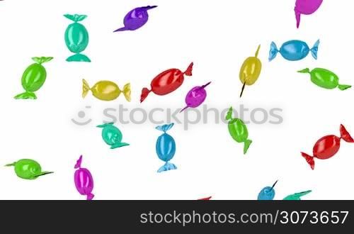 Falling colorful wrapped candies on white background
