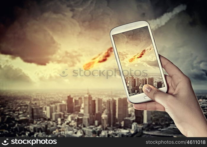 Falling meteorite. Close up of human hands taking photo of falling meteorite