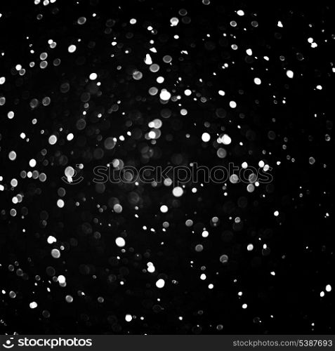 Falling snow background - snowflakes over night dark sky