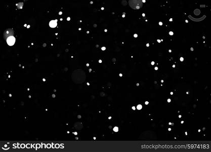 Falling snow background - snowflakes over night dark sky. Snow background