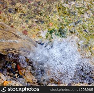 falling water in little waterfall in water spring source