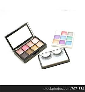false lashes and cosmetic eyeshadow palette makeup set isolated on white background