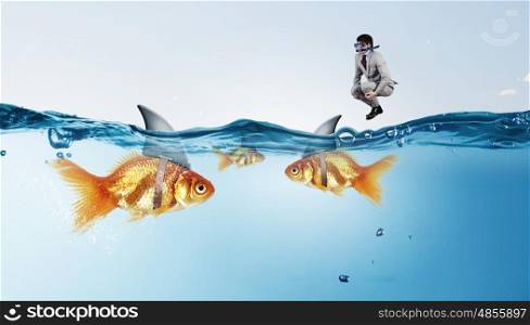 False risk for your business. Concept of fake threat when businessman jump in water with shark appear to be goldfish