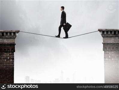 False risk for your business. Concept of false danger with businessman walking on rope above water