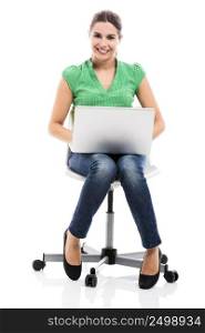 Famele happy student sitting on a chair with a laptop, isolated over a white background