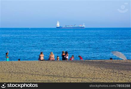 Families enjoy the blue sea on the beach Malagueta in Malaga Spain