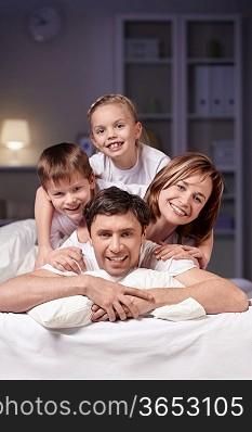 Families in bed at night at home