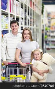 Families with a child makes a purchase in a store