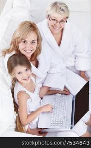 Families with a laptop on a white sofa