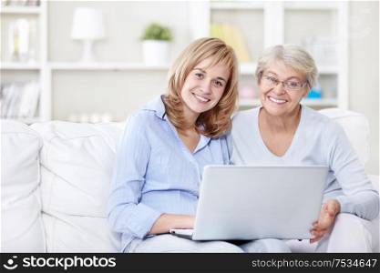 Families with a laptop on the couch