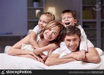 Families with children in bed at night at home