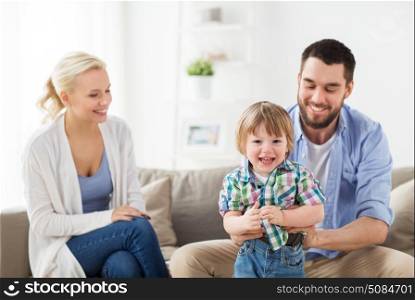 family, adoption and people concept - happy child with parents at home. happy family at home. happy family at home