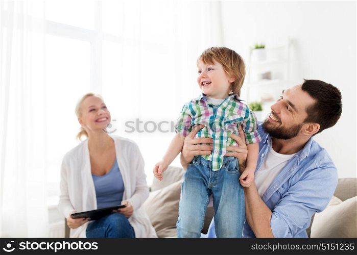 family, adoption and people concept - happy child with parents at home. happy family at home