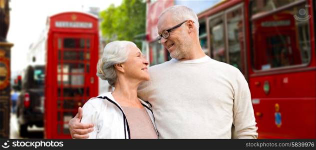 family, age, tourism, travel and people concept - happy senior couple over london city street in england