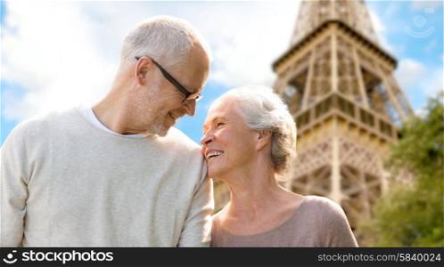 family, age, tourism, travel and people concept - happy senior couple over paris eiffel tower in france