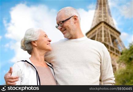 family, age, tourism, travel and people concept - happy senior couple over paris eiffel tower in france