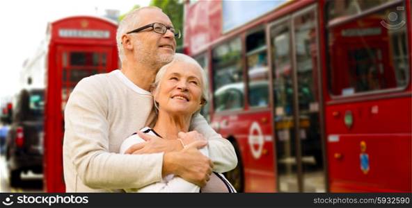 family, age, tourism, travel and people concept - happy senior couple over london city street in england
