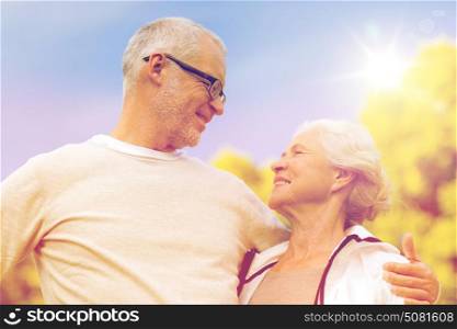 family, age, tourism, travel and people concept - senior couple hugging in city park. senior couple hugging in city park