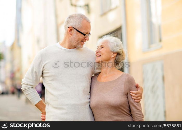 family, age, tourism, travel and people concept - senior couple hugging on city street