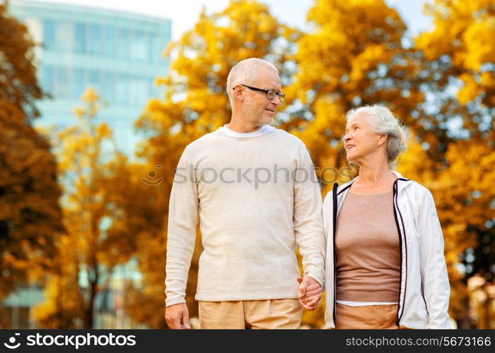 family, age, tourism, travel and people concept - senior couple in city park