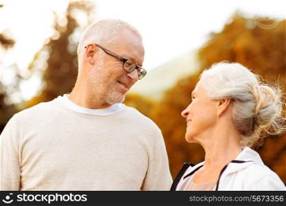 family, age, tourism, travel and people concept - senior couple in city park