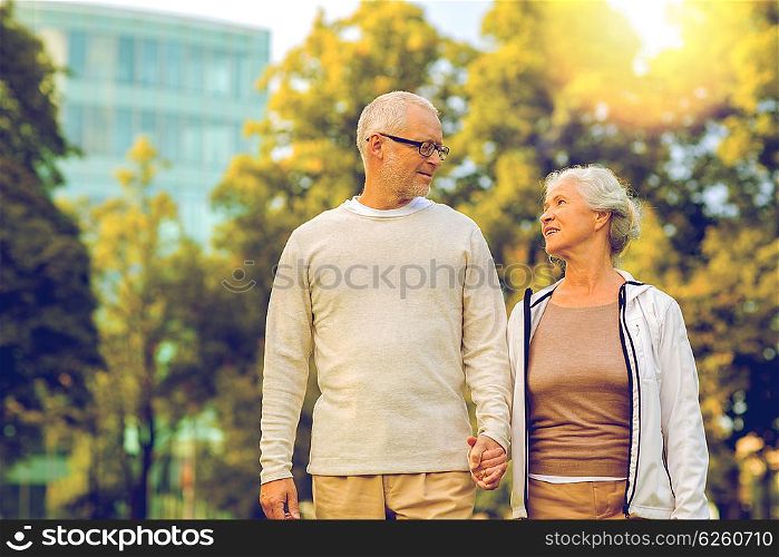 family, age, tourism, travel and people concept - senior couple in city park