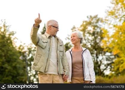 family, age, tourism, travel and people concept - senior couple in park