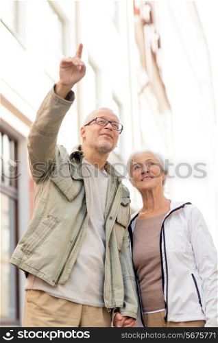 family, age, tourism, travel and people concept - senior couple on city street
