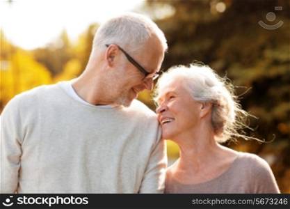 family, age, tourism, travel and people concept - senior couple walking in park