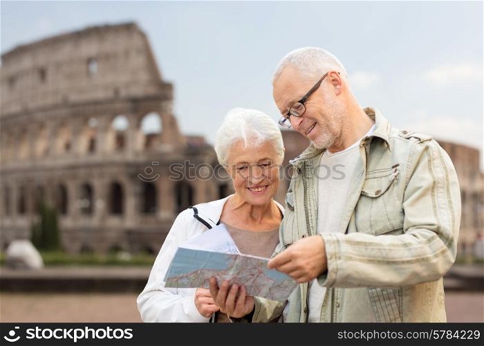 family, age, tourism, travel and people concept - senior couple with map and city guide on street over coliseum background