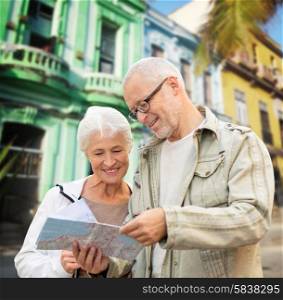 family, age, tourism, travel and people concept - senior couple with map over latin american city street background