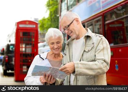 family, age, tourism, travel and people concept - senior couple with map over london city street background