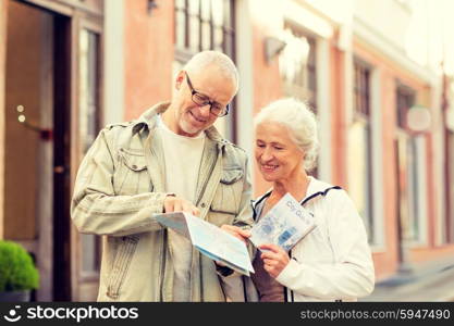 family, age, tourism, travel and people concept - senior couple with map and city guide on street