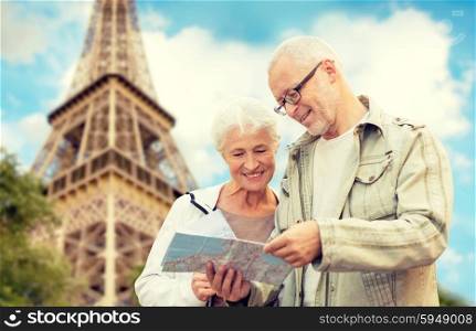 family, age, tourism, travel and people concept - senior couple with map and city guide over eiffel tower and blue sky background