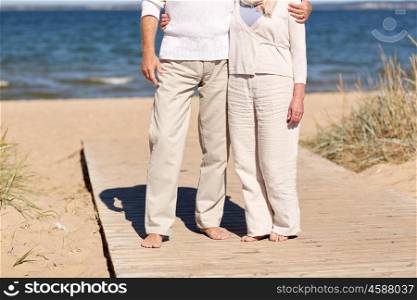 family, age, travel, tourism and people concept - close up of senior couple hugging on summer beach