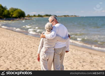 family, age, travel, tourism and people concept - happy senior couple hugging on summer beach