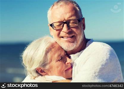 family, age, travel, tourism and people concept - happy senior couple hugging on summer beach