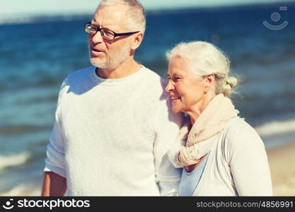 family, age, travel, tourism and people concept - happy senior couple hugging on summer beach