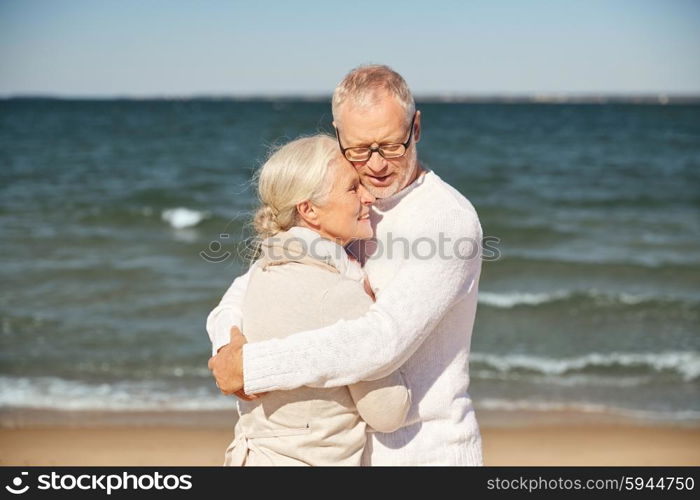 family, age, travel, tourism and people concept - happy senior couple hugging on summer beach